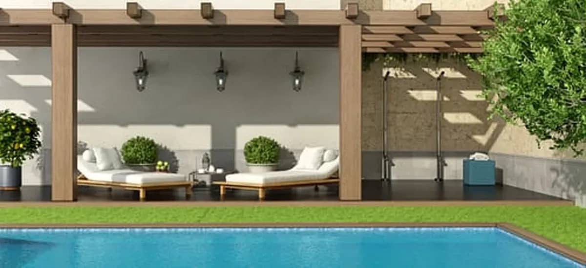 Remodeled backyard with pergola lounge seating beside a swimming pool